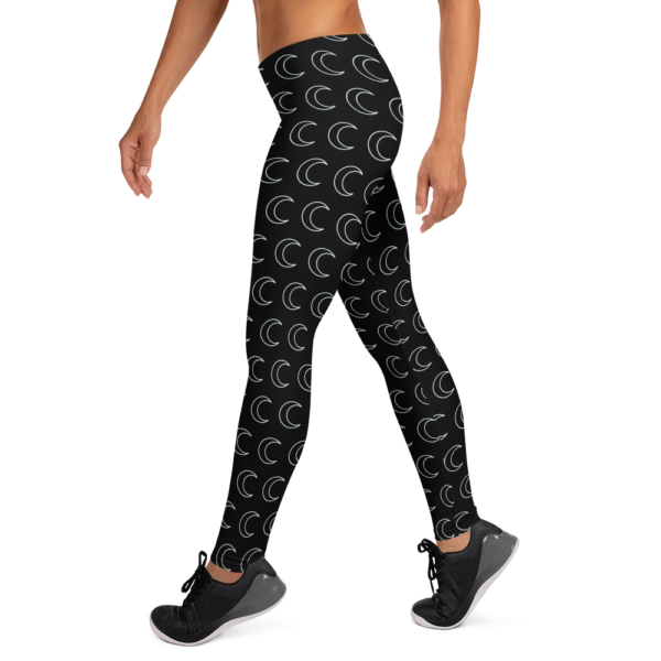woman wearing black leggings with white crescent moon pattern