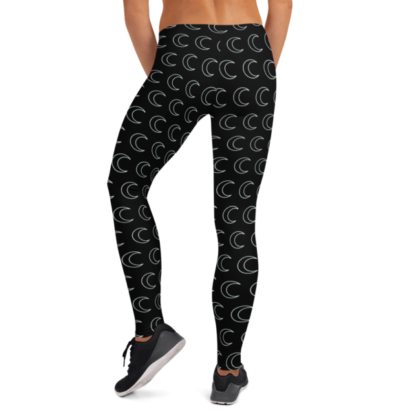 woman wearing black leggings with white crescent moon pattern