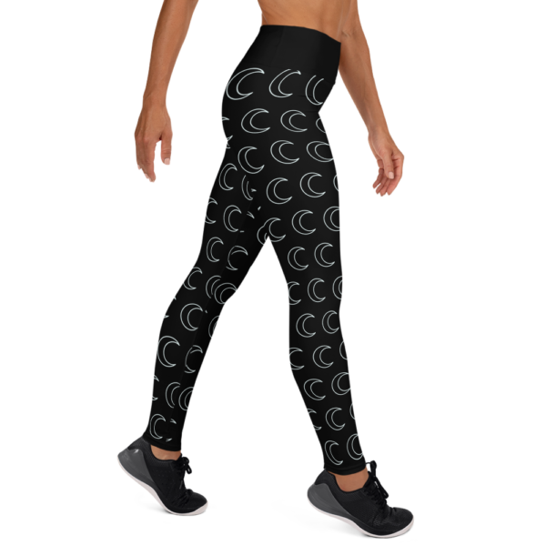 woman wearing black yoga leggings with white crescent moon pattern