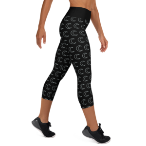 woman wearing black yoga capri leggings with white crescent moon pattern